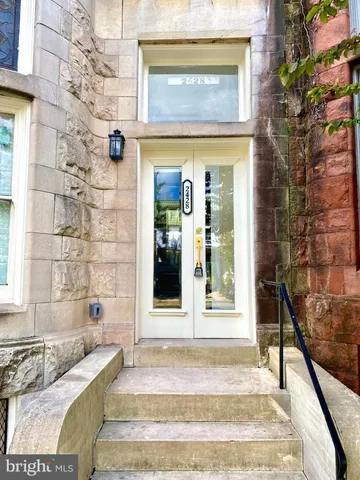 a view of a brick house with a large windows