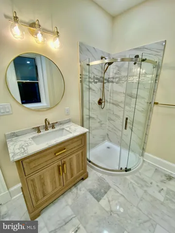 a bathroom with a sink mirror toilet and shower