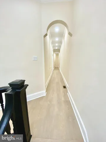 an empty room with windows and ceiling fan