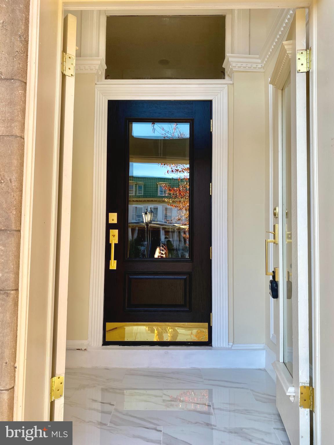 2428 Eutaw Place Baltimore, MD 21217 - Photo 3 of 48 a view of a hallway with wooden floor and a fireplace