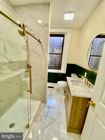 a bathroom with a shower and toilet
