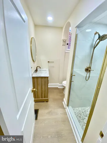 a bathroom with a granite countertop shower and a sink