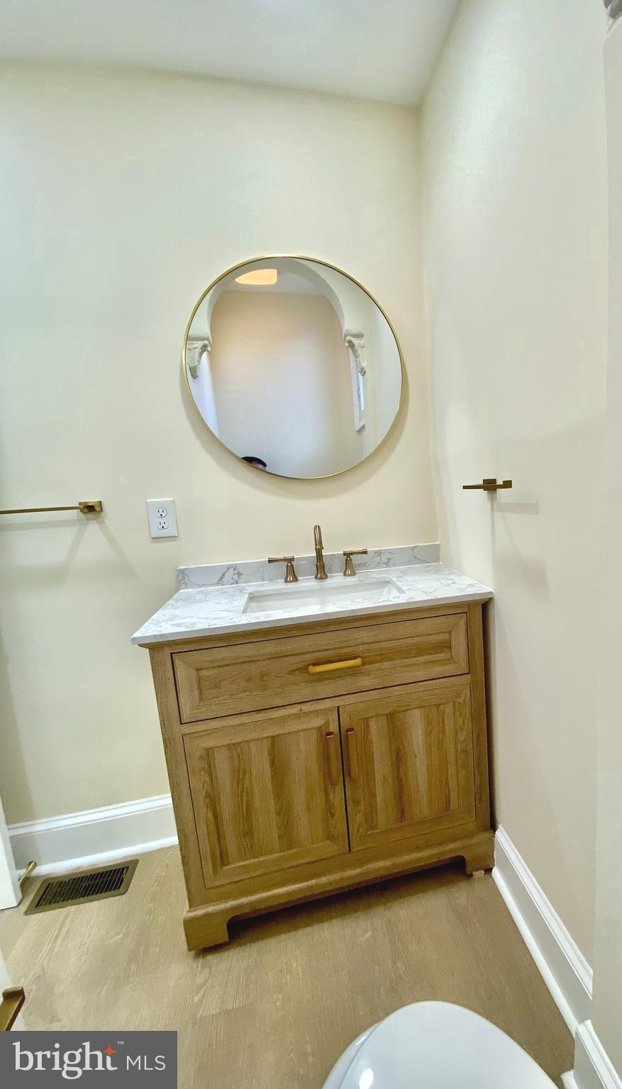 2428 Eutaw Place Baltimore, MD 21217 - Photo 39 of 48 a bathroom with a sink mirror and vanity