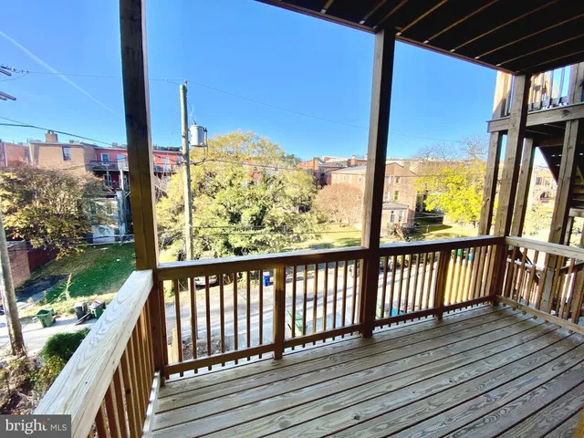 a front view of a building with a garden