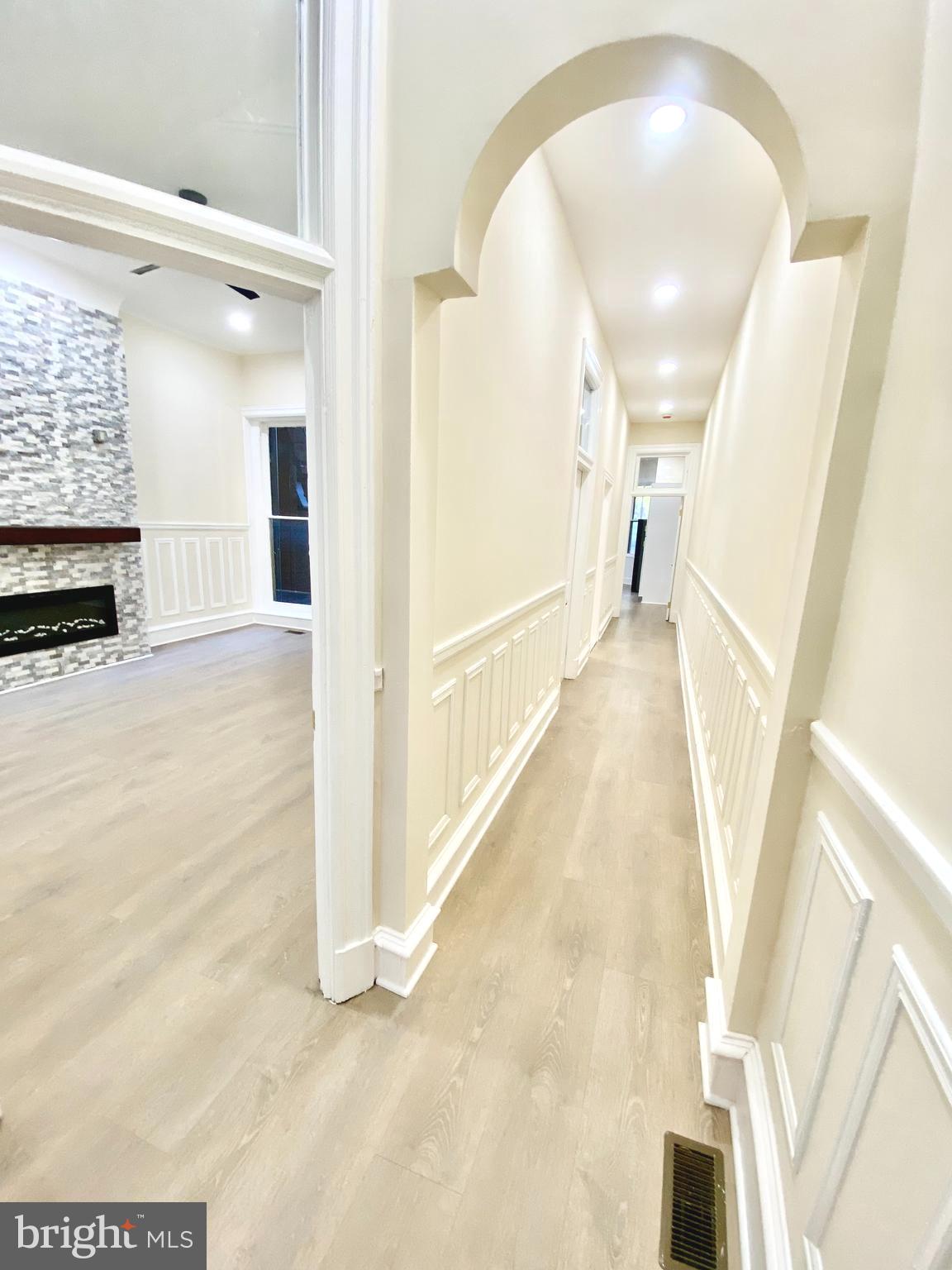 2428 Eutaw Place Baltimore, MD 21217 - Photo 9 of 48 a view of a hallway with wooden floor and staircase
