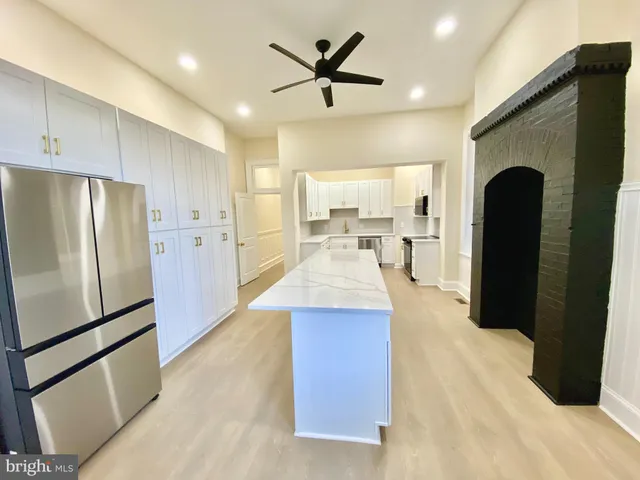 a kitchen with refrigerator and cabinets