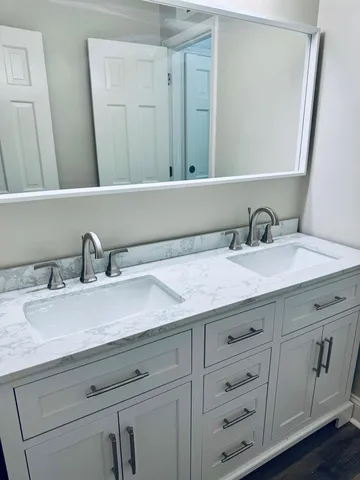 a bathroom with a sink and a mirror