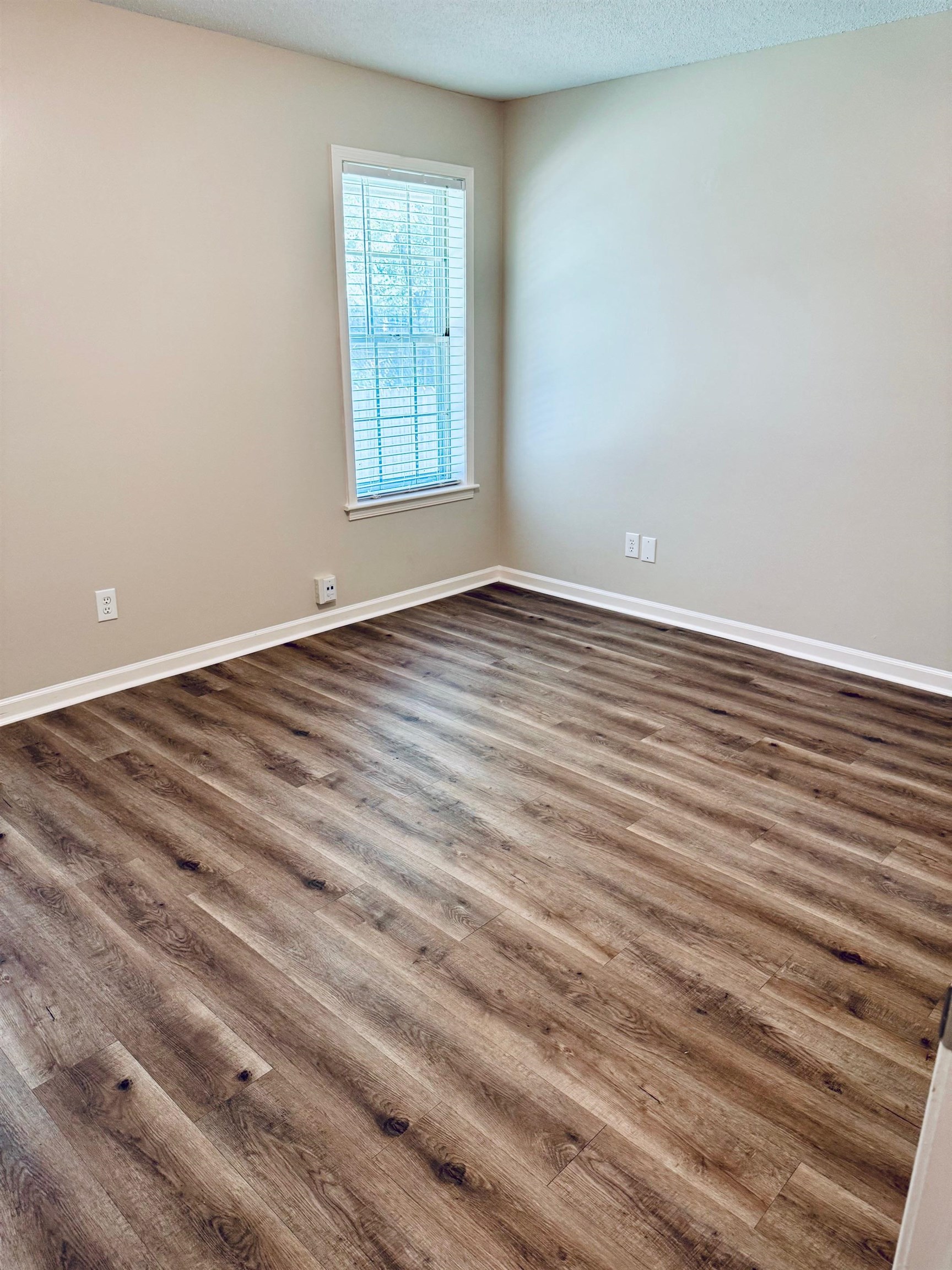 2212 Howard Road Germantown, TN 38138 - Photo 18 of 24 an empty room with wooden floor and windows