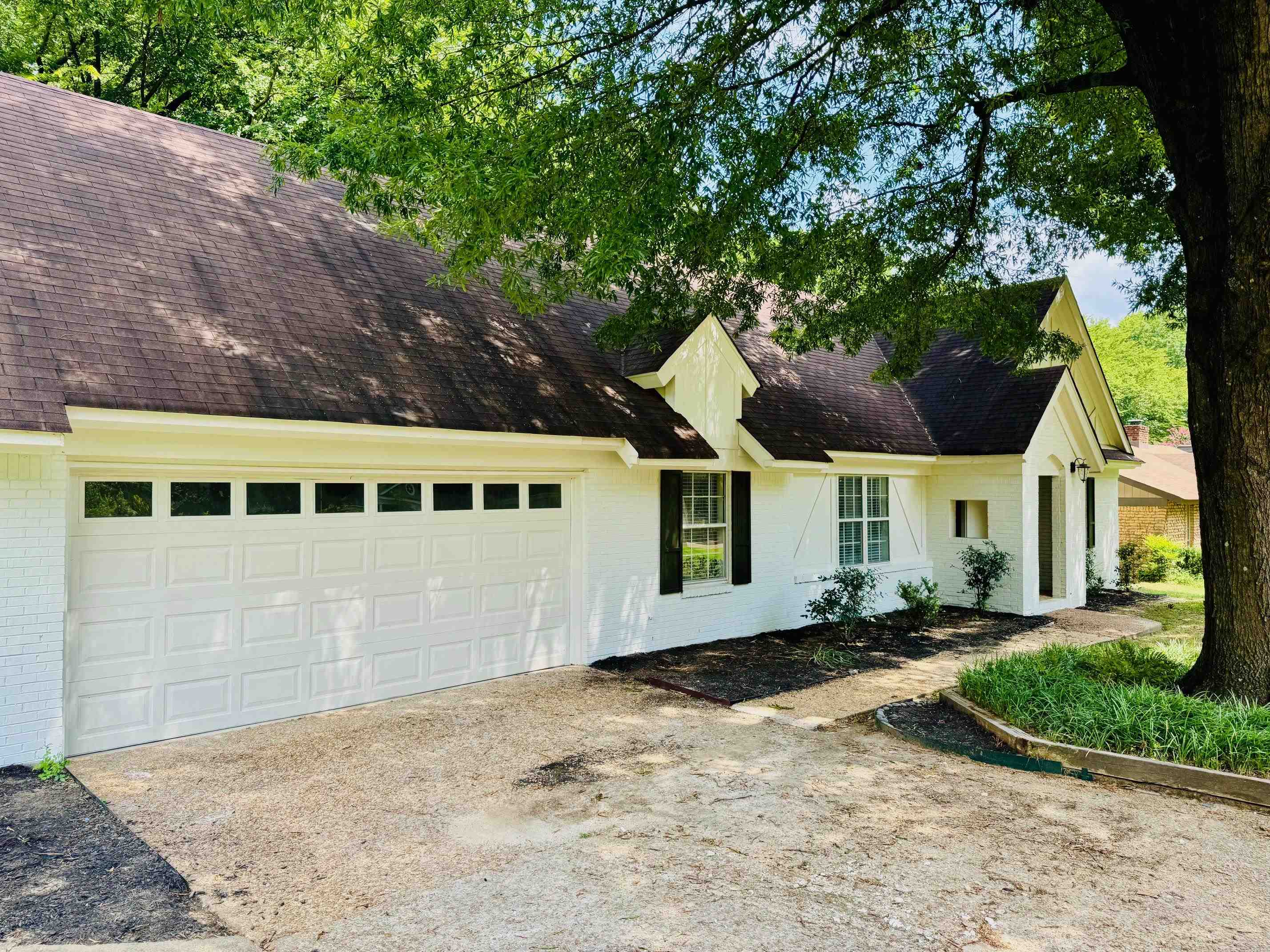 2212 Howard Road Germantown, TN 38138 - Photo 3 of 24 a front view of a house with a yard and garage
