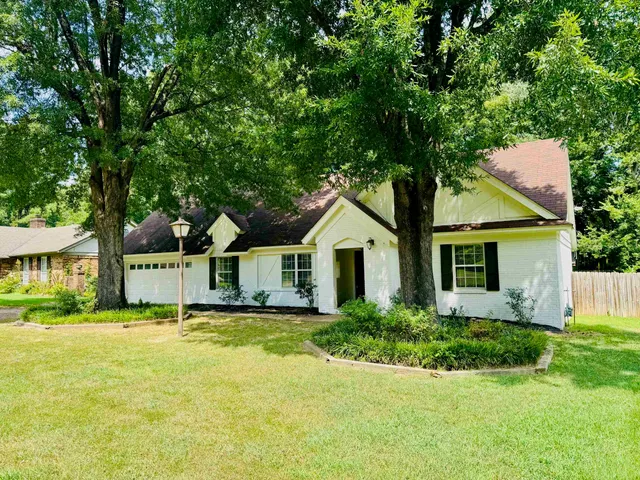 a front view of house with yard and green space