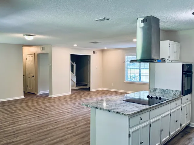 a kitchen with sink cabinets and wooden floor
