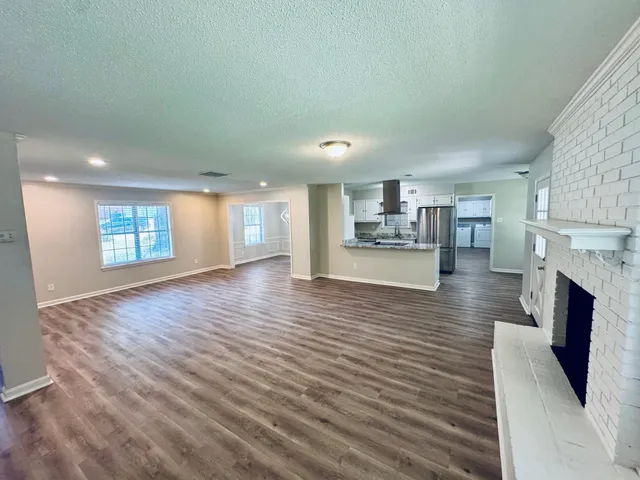a view of a living room a fireplace with wooden floor