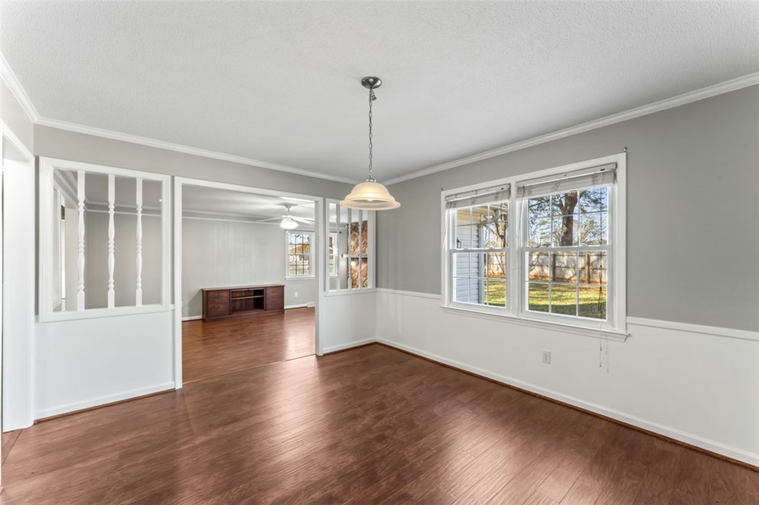 304 Stonehaven Drive Anderson, SC 29625 - Photo 6 of 19 Hardwood flooring extends throughout this versatile space, featuring ample natural illumination from large windows.