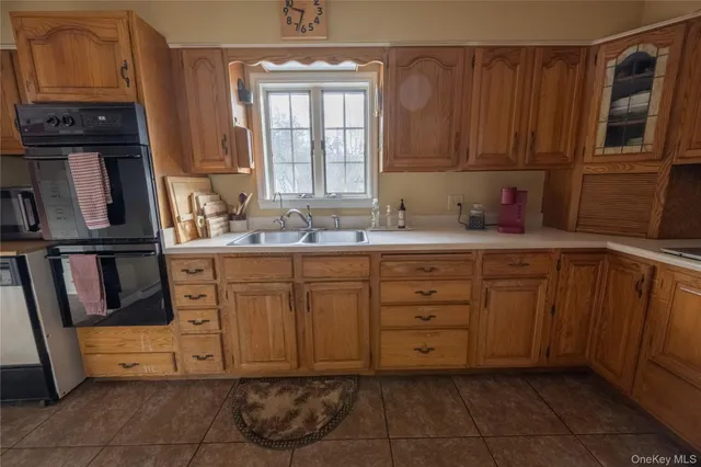 a kitchen with a sink window and cabinets
