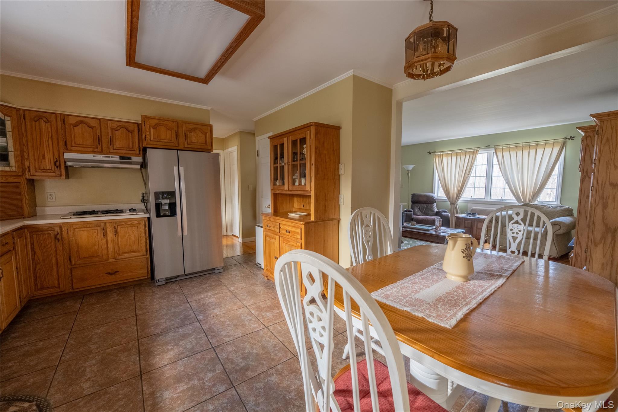 5028-5030 Rt-82 Millbrook, NY 12578 - Photo 15 of 50 a kitchen with stainless steel appliances kitchen island granite countertop a table chairs in it and wooden floors