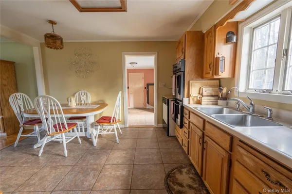a dining room with furniture and a large window