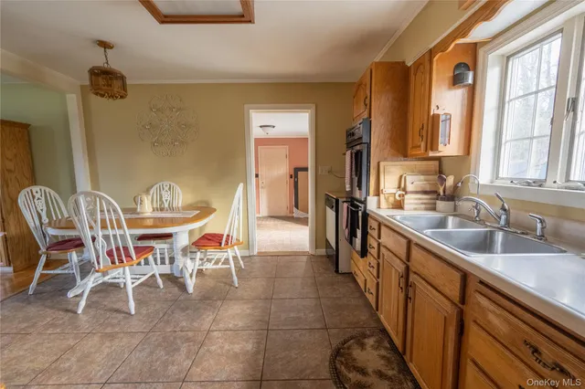 a dining room with furniture and a large window