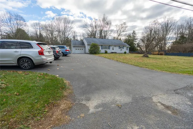 a view of a street with a cars parked in front of it