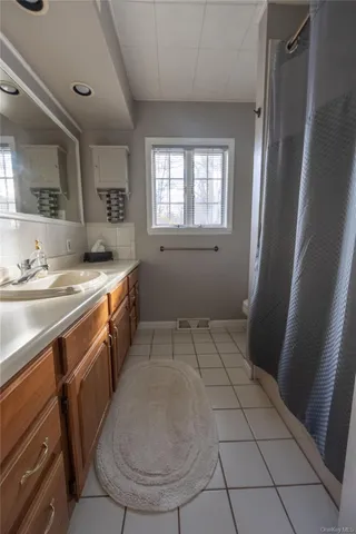 a kitchen with a sink a stove cabinets and a counter top space
