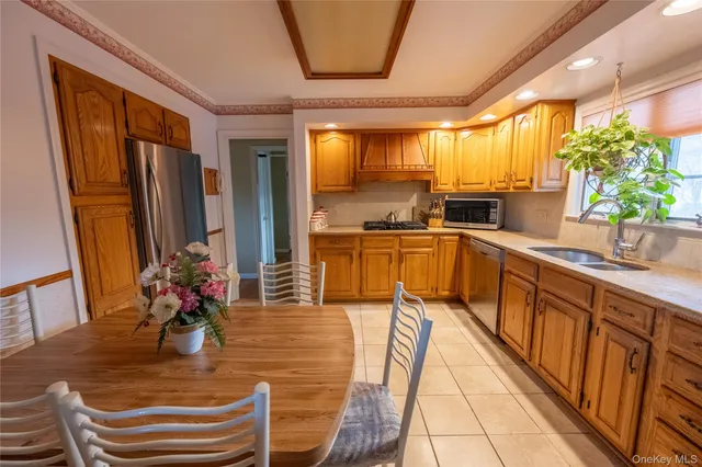 a kitchen with sink refrigerator and large window