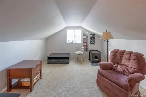 a living room with furniture and a lamp