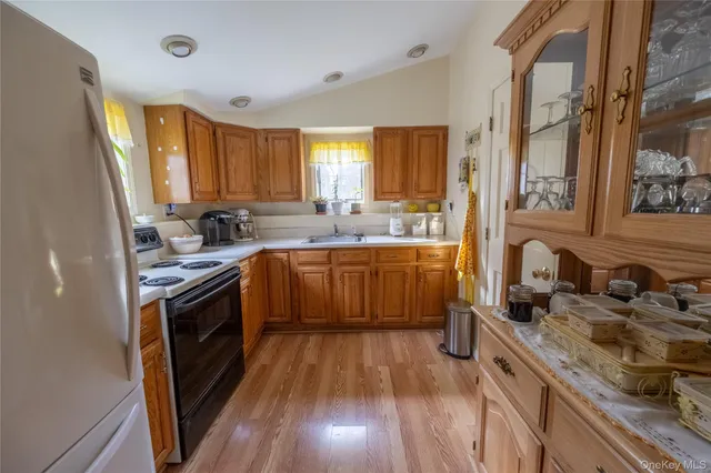 a kitchen with wooden floors and sink
