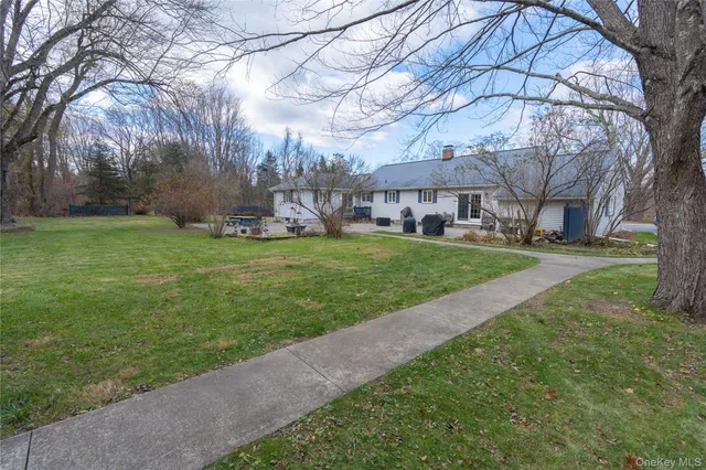 a view of a yard with a house in the background