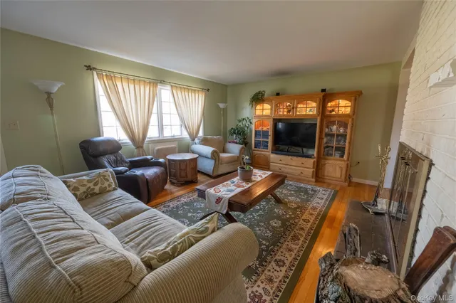 a living room with furniture a large window and a flat screen tv