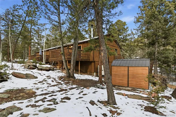 a view of a house with a yard covered in snow