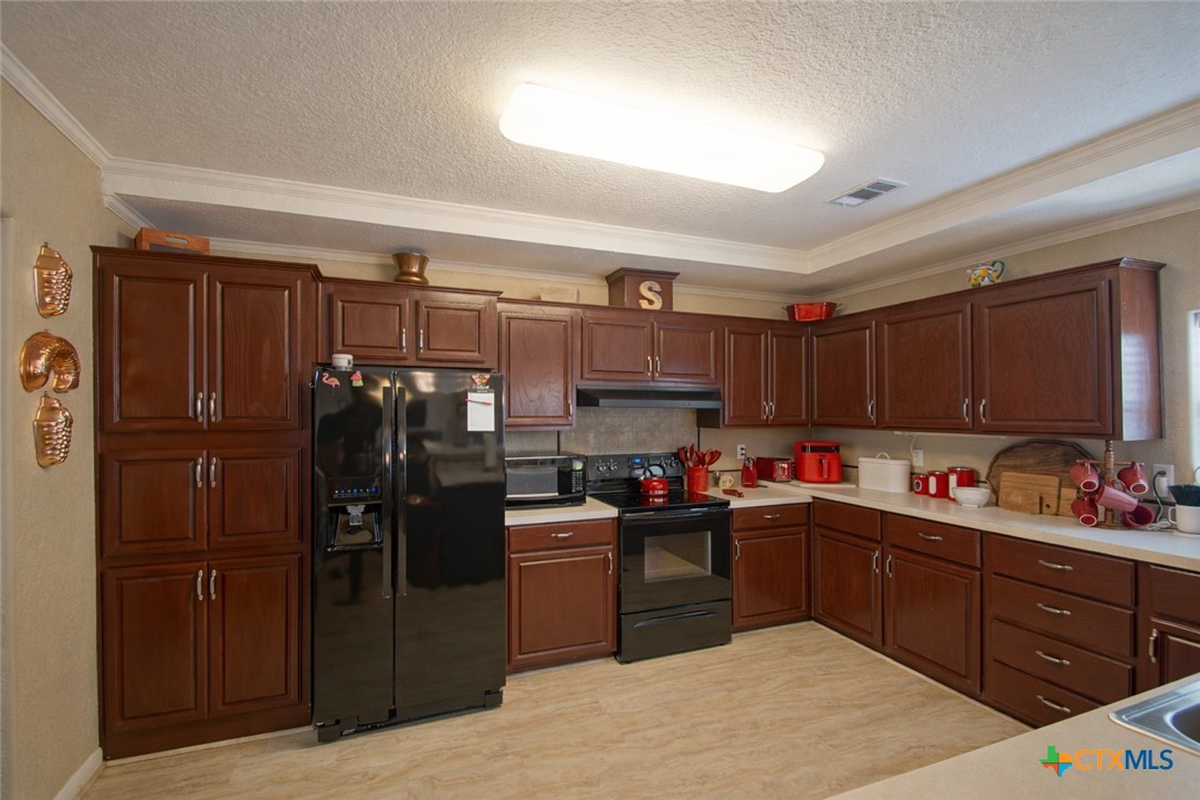 73 Rose Way North Victoria, TX 77905 - Photo 12 of 44 a kitchen with refrigerator and cabinets