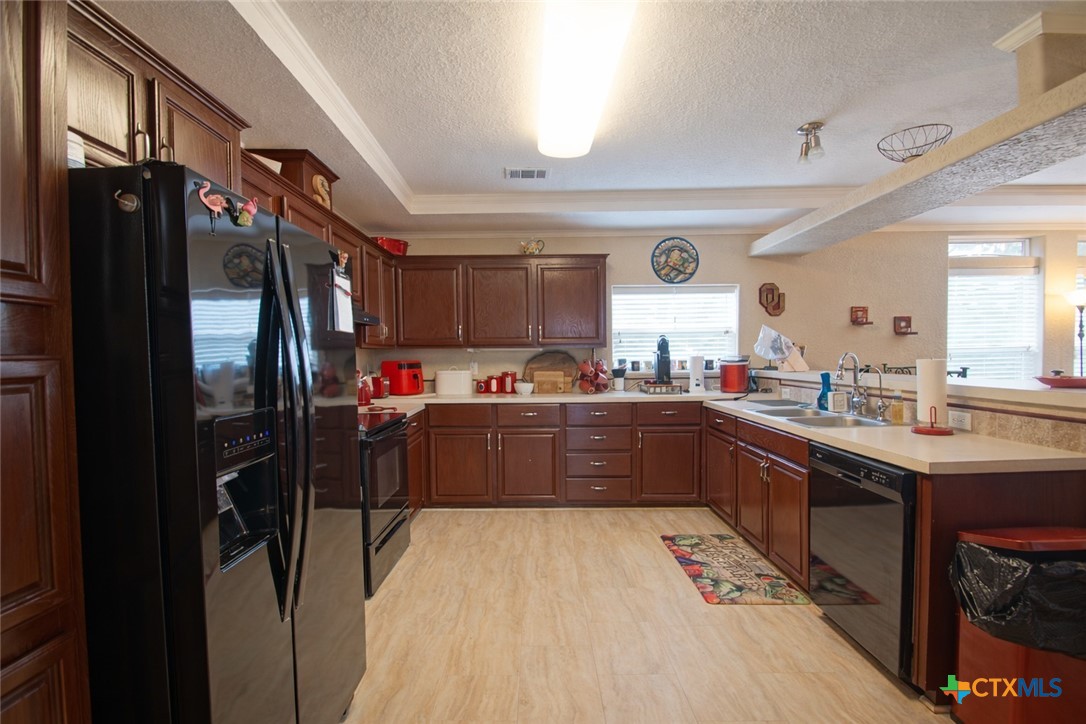 73 Rose Way North Victoria, TX 77905 - Photo 13 of 44 a kitchen with stainless steel appliances kitchen island granite countertop a refrigerator and a sink