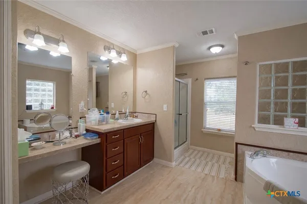 a bathroom with a granite countertop sink mirror and a bathtub