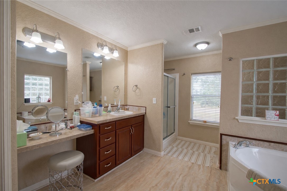 73 Rose Way North Victoria, TX 77905 - Photo 18 of 44 a bathroom with a granite countertop sink mirror and a bathtub