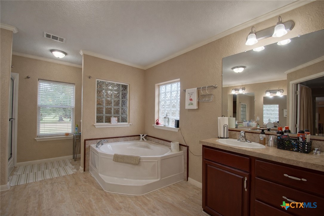 73 Rose Way North Victoria, TX 77905 - Photo 20 of 44 a spacious bathroom with a tub sink and mirror