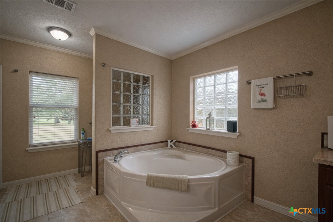 73 Rose Way North Victoria, TX 77905 - Photo 21 of 44 a bath tub sitting in a bathroom next to a window