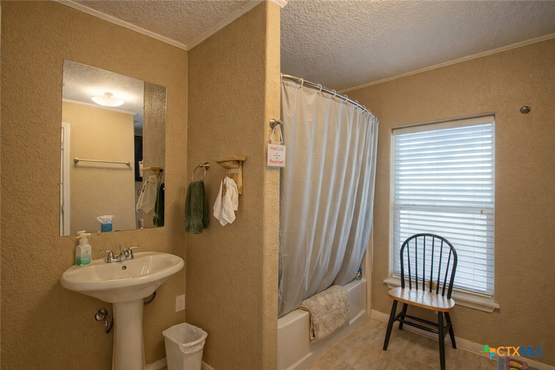 73 Rose Way North Victoria, TX 77905 - Photo 24 of 44 a bathroom with a sink a chair and a mirror