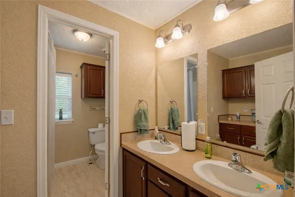 a bathroom with a sink double vanity granite and a mirror