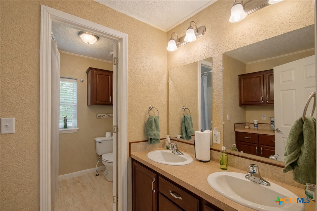 73 Rose Way North Victoria, TX 77905 - Photo 26 of 44 a bathroom with a sink double vanity granite and a mirror