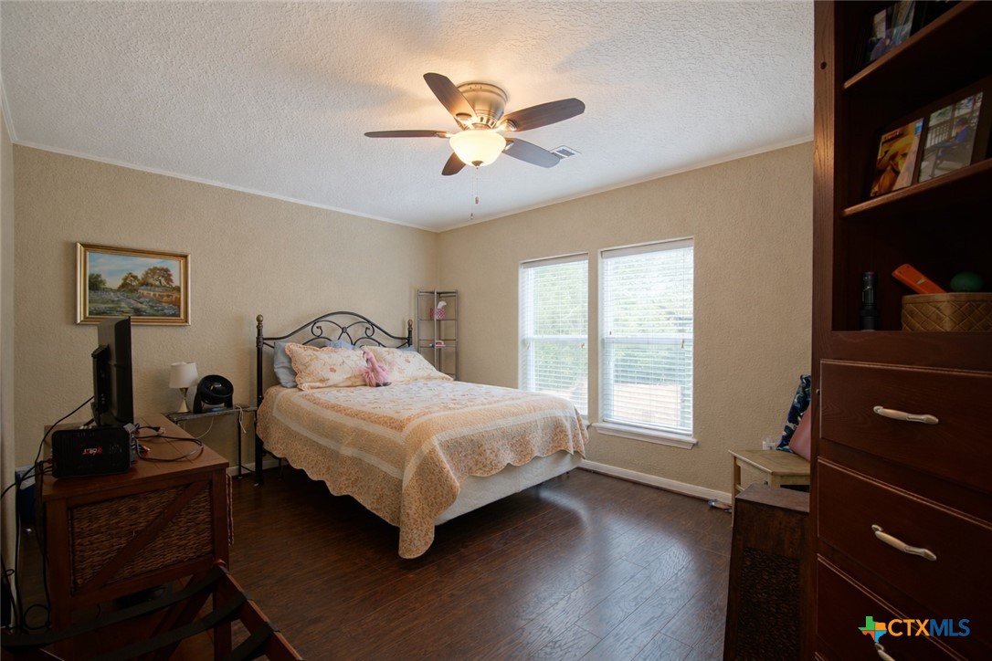 73 Rose Way North Victoria, TX 77905 - Photo 28 of 44 a bedroom with a bed and wooden floor