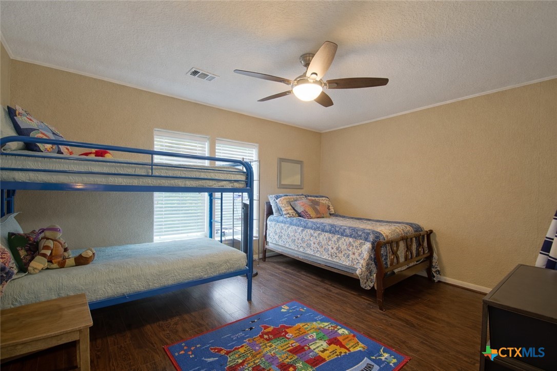 73 Rose Way North Victoria, TX 77905 - Photo 31 of 44 a bedroom with a bed and a chandelier