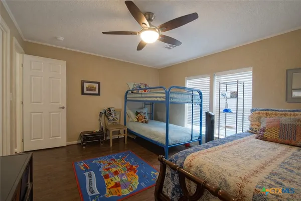 a bedroom with bed and wooden floor