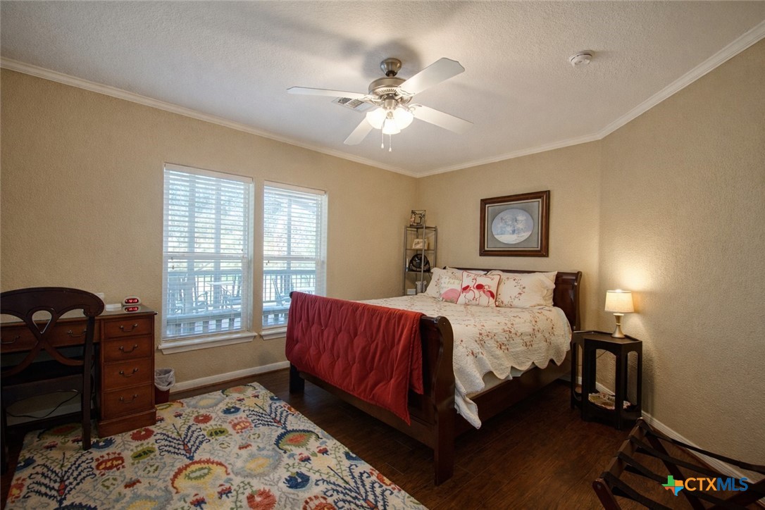 73 Rose Way North Victoria, TX 77905 - Photo 33 of 44 a bedroom with a bed and a chandelier