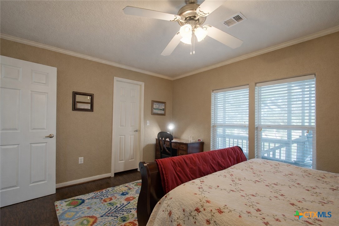 73 Rose Way North Victoria, TX 77905 - Photo 34 of 44 a bedroom with a bed and wooden floor