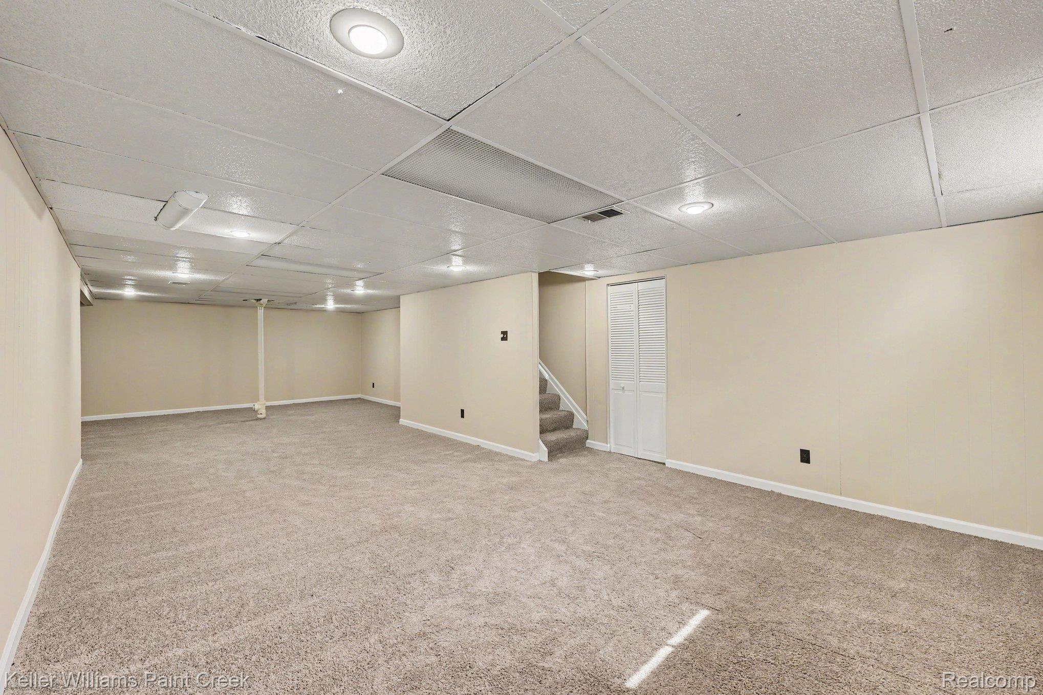 2717 Powderhorn Ridge Road Rochester, MI 48309 - Photo 28 of 48 Expansive carpeted area with recessed lighting and neutral wall tones