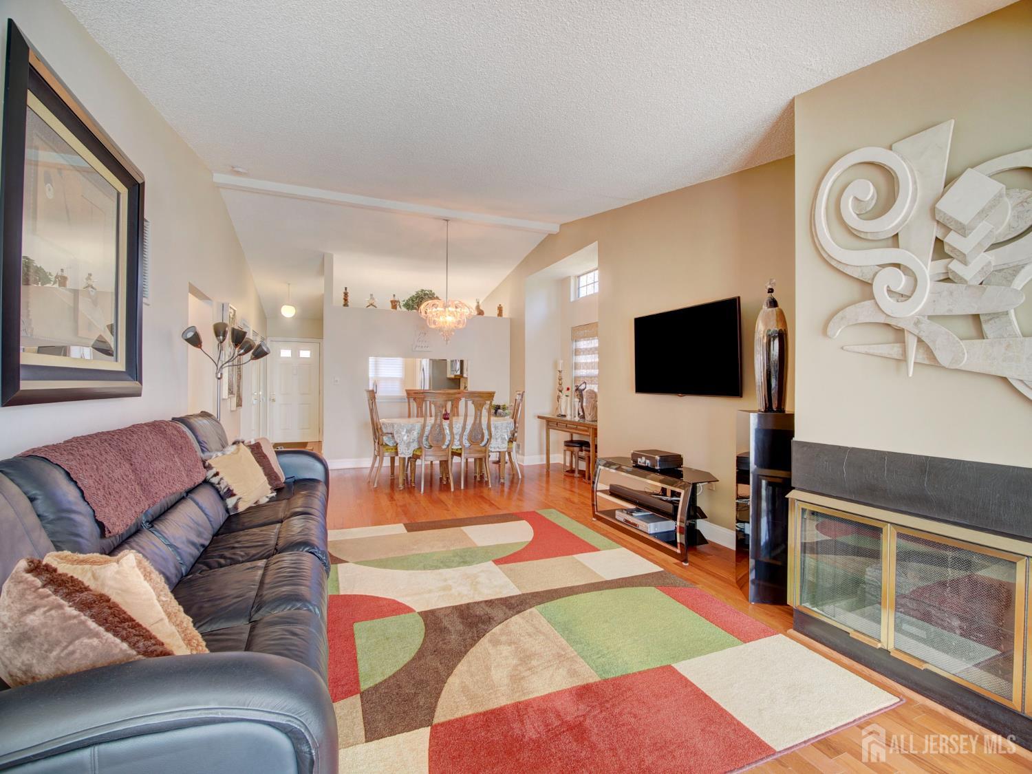 136 Wycoff Way West East Brunswick, NJ 08816 - Photo 11 of 28 a living room with furniture and a flat screen tv
