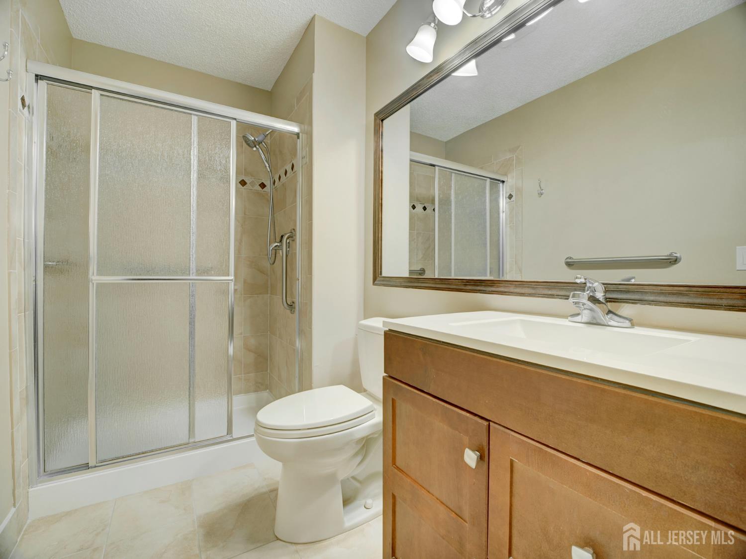 136 Wycoff Way West East Brunswick, NJ 08816 - Photo 14 of 28 a bathroom with a sink toilet and shower