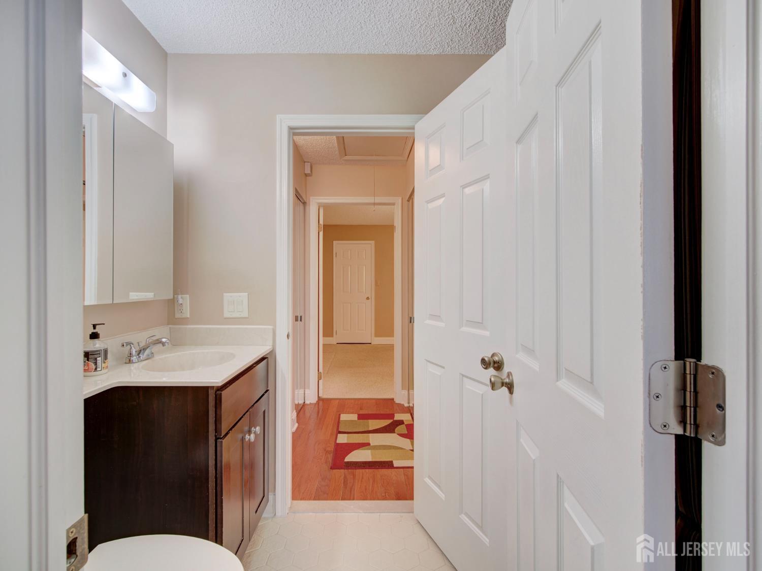 136 Wycoff Way West East Brunswick, NJ 08816 - Photo 17 of 28 a en suite bathroom with a sink and a mirror