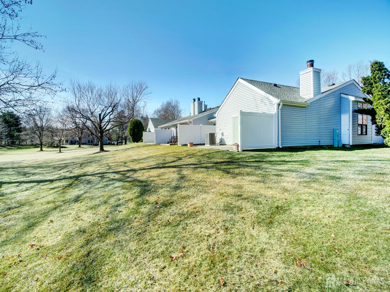 136 Wycoff Way West East Brunswick, NJ 08816 - Photo 23 of 28 a big house with a big yard and large trees