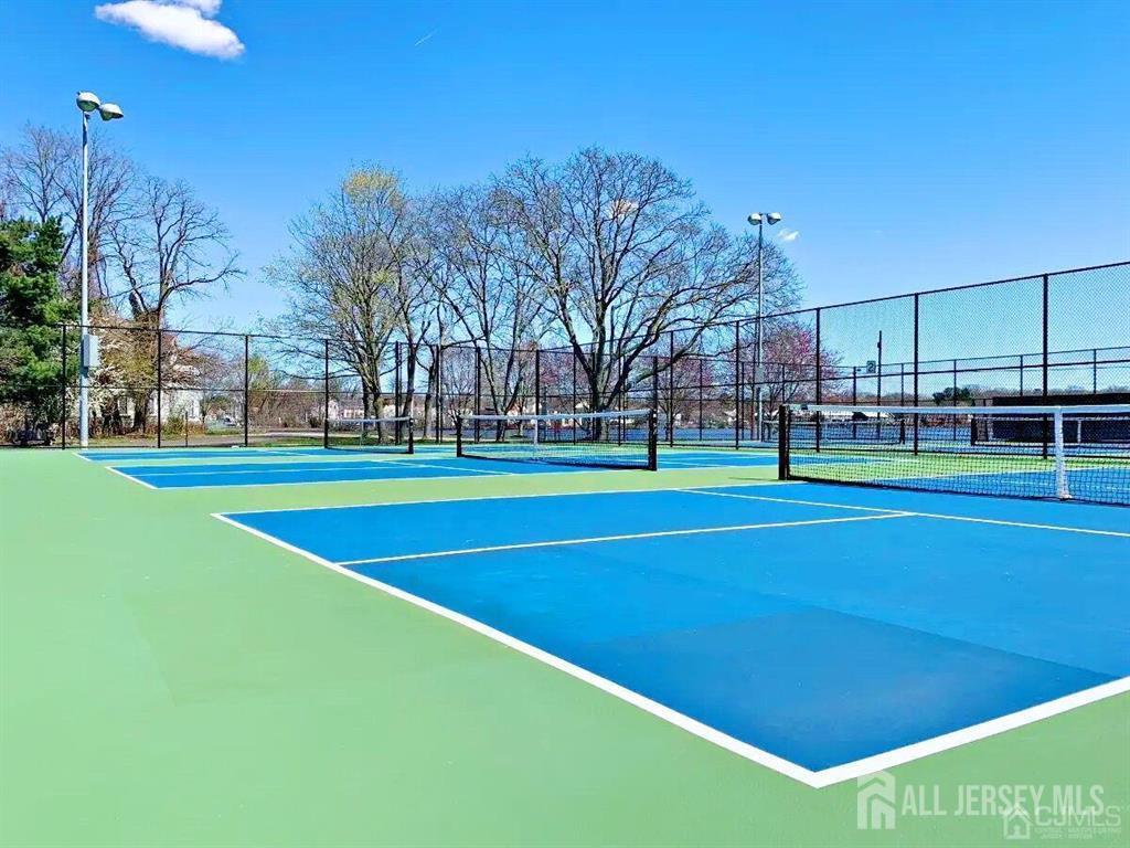 136 Wycoff Way West East Brunswick, NJ 08816 - Photo 28 of 28 a view of a tennis ground with large trees