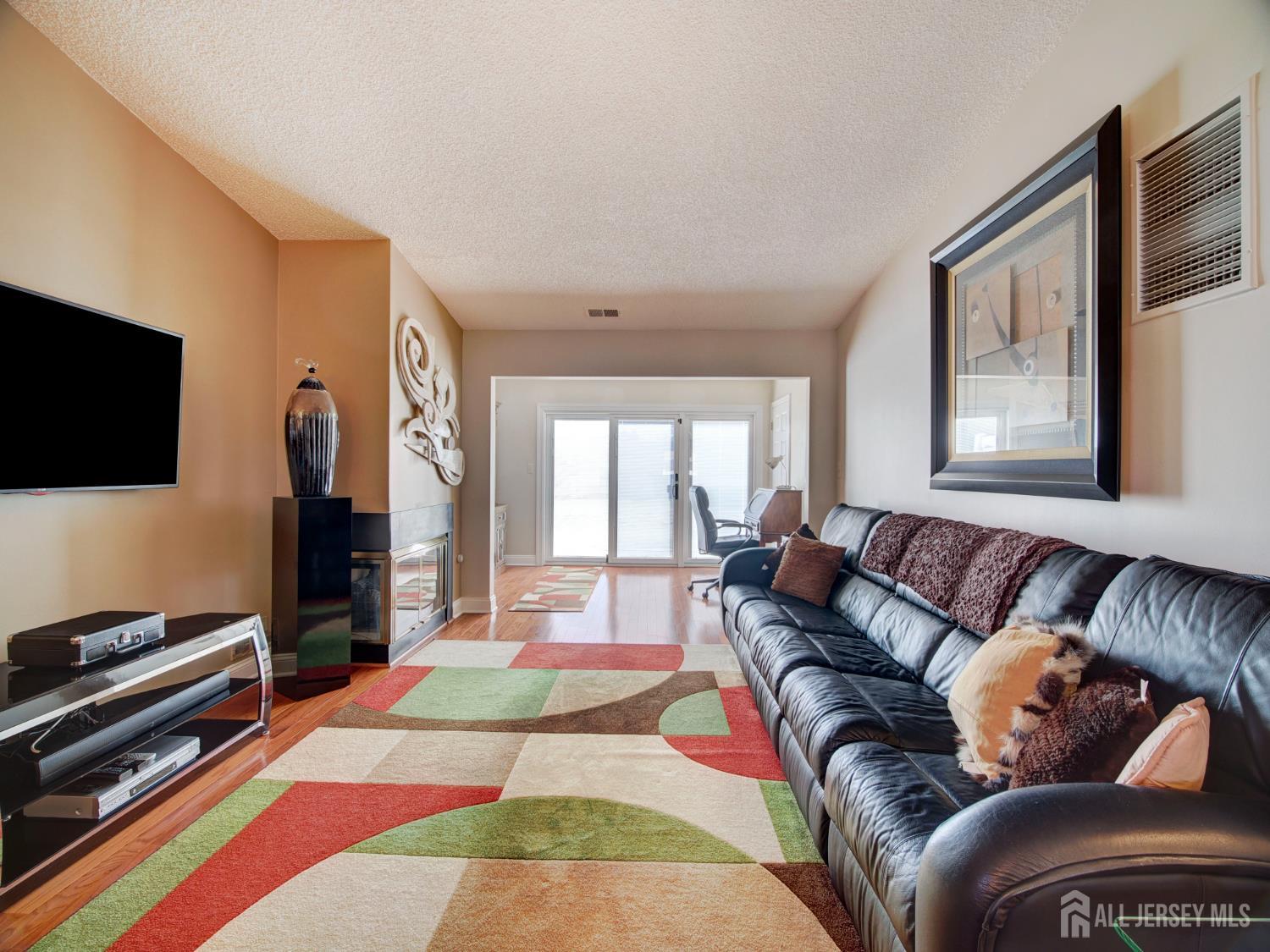 136 Wycoff Way West East Brunswick, NJ 08816 - Photo 5 of 28 a living room with furniture and a flat screen tv